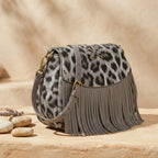 Grey small fringe leather crossbody bag, three-quarter angle showing side depth