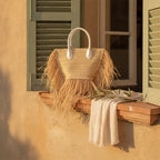 Natural small fringe tote bag styled in a warm Mediterranean setting