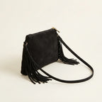 Black small suede fringe bag, three-quarter angle showing side depth