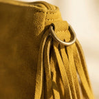 Close-up of fringe stitching and texture on Green small suede fringe bag