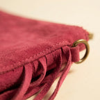 Close-up of fringe stitching and texture on Pink small suede fringe bag
