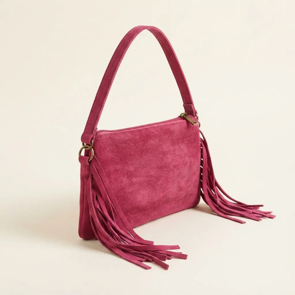 Pink small suede fringe bag, three-quarter angle showing side depth
