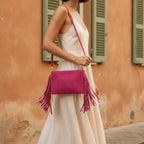 Woman wearing Pink small suede fringe bag with swaying fringe
