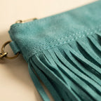 Close-up of fringe stitching and texture on Turquoise small suede fringe bag