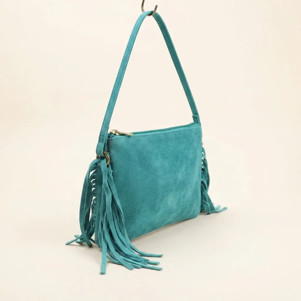 Turquoise small suede fringe bag, three-quarter angle showing side depth