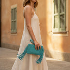 Woman wearing Turquoise small suede fringe bag with swaying fringe