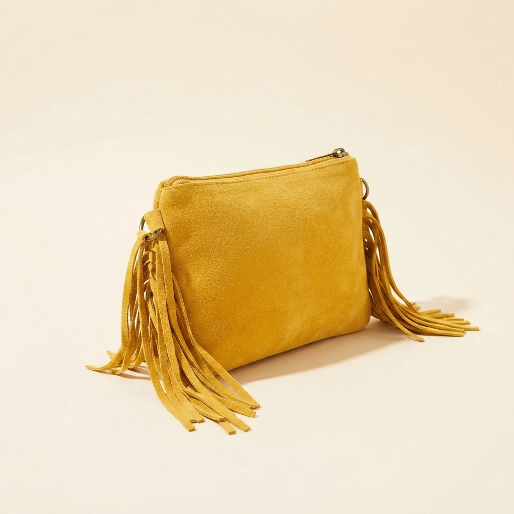 Yellow small suede fringe bag, three-quarter angle showing side depth