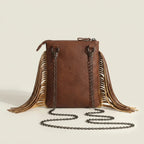 Back panel of Brown studded fringe crossbody bag with strap attachments