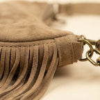 Close-up of fringe stitching and texture on Camel suede fringe clutch bag