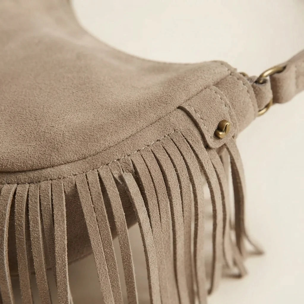 Close-up of fringe stitching and texture on Taupe suede fringe clutch bag