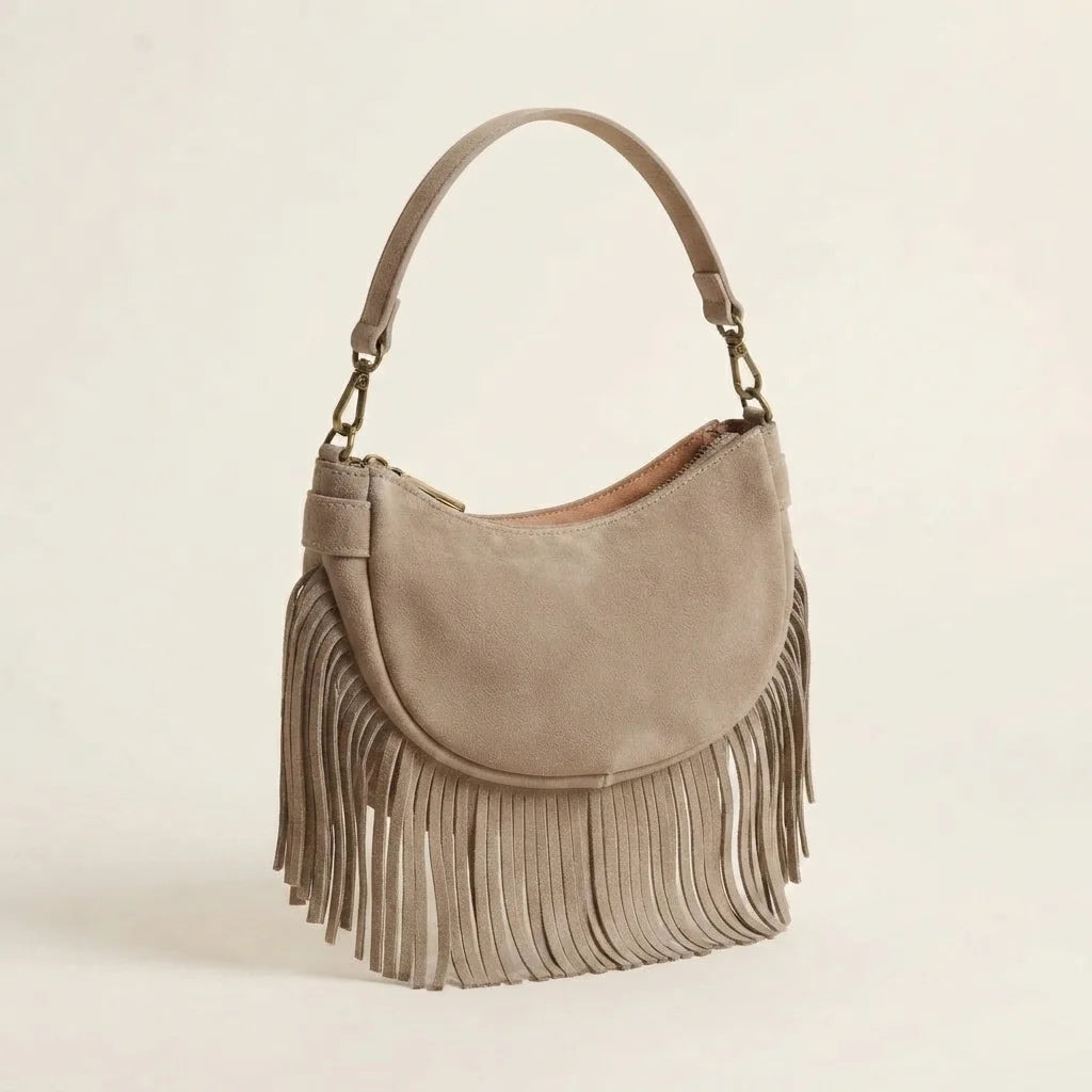 Taupe suede fringe clutch bag, three-quarter angle showing side depth