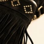 Close-up of fringe stitching and texture on Black suede fringe messenger bag