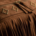 Close-up of fringe stitching and texture on Brown suede fringe messenger bag