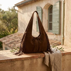 Coffee suede leather fringe bag styled in a warm Mediterranean setting
