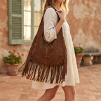 Woman wearing Coffee suede leather fringe bag with swaying fringe