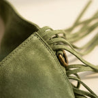 Close-up of fringe stitching and texture on Green suede leather fringe bag