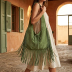 Woman wearing Green suede leather fringe bag with swaying fringe