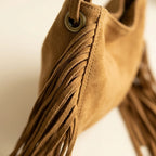 Close-up of fringe stitching and texture on Khaki tan fringe bag