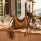 Khaki tan fringe bag styled in a warm Mediterranean setting