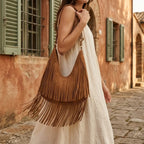 Woman wearing Brown tan fringe hobo bag with swaying fringe