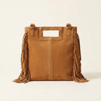 Back panel of Camel tan fringe shoulder bag with strap attachments
