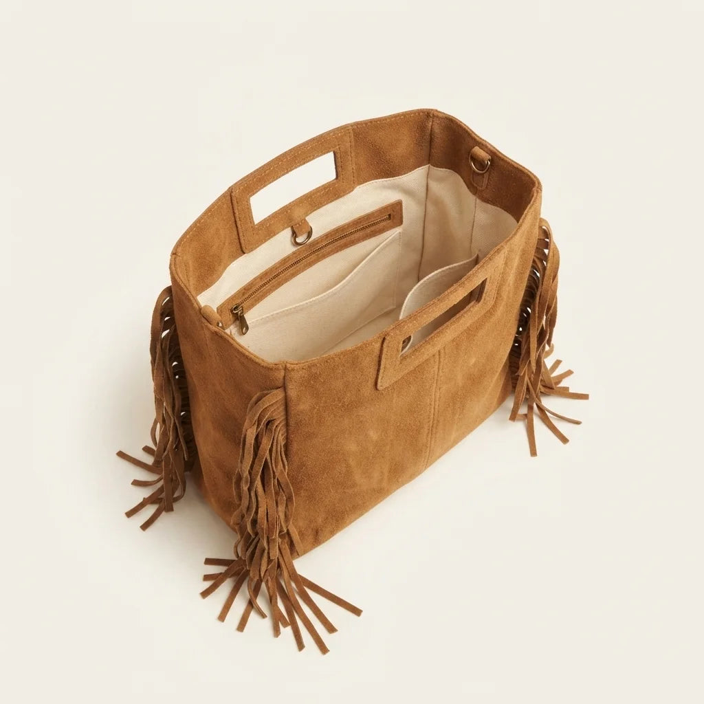 Interior lining and pockets of Camel tan fringe shoulder bag