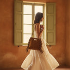 Woman wearing Camel tan fringe shoulder bag with swaying fringe