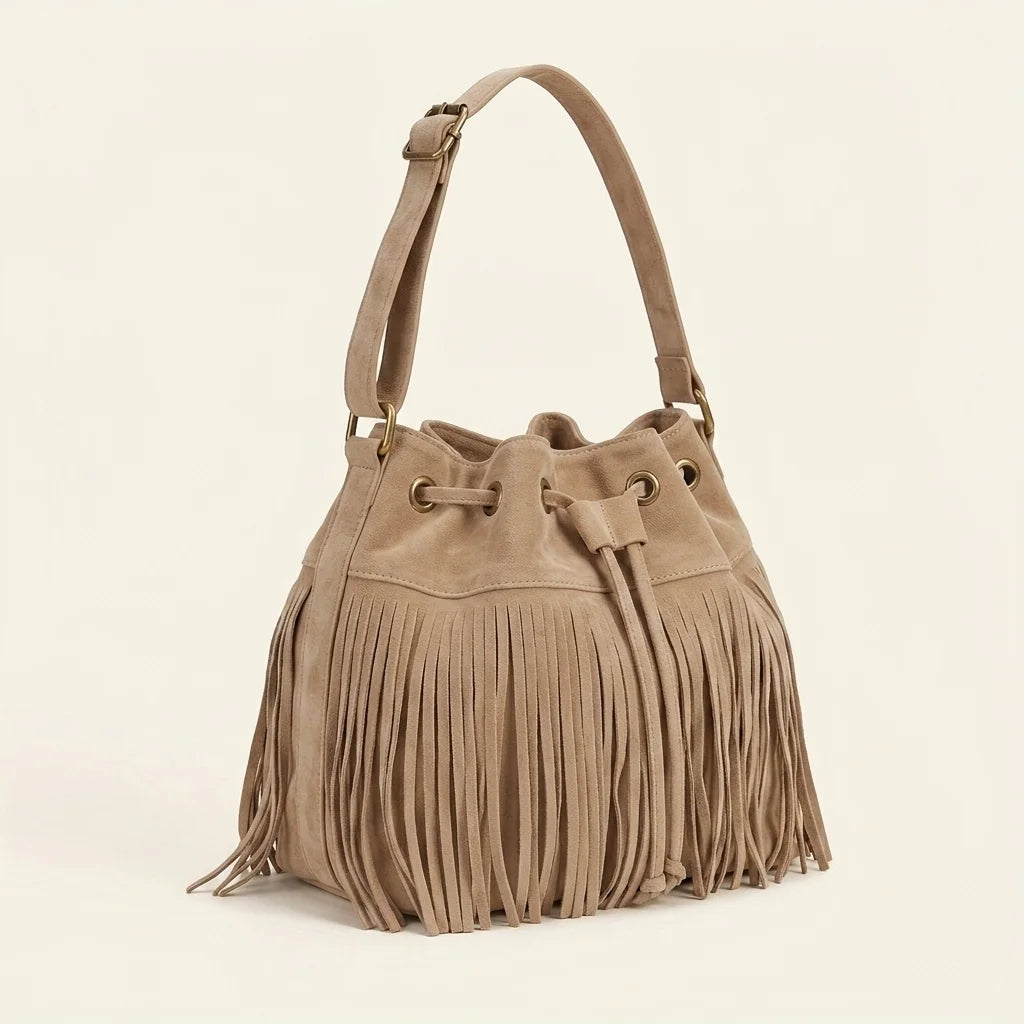 Khaki tan suede fringe bucket bag, three-quarter angle showing side depth