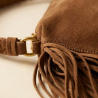 Close-up of fringe stitching and texture on Brown tan suede fringe clutch bag