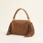 Brown tan suede fringe clutch bag, three-quarter angle showing side depth