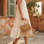 Woman wearing Khaki tassel fringe clutch bag with swaying fringe