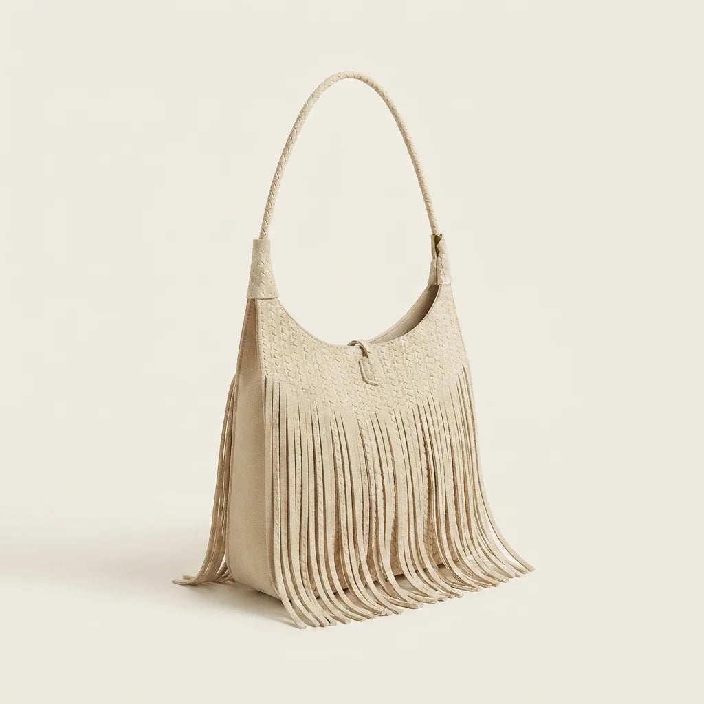 Beige tassel fringe hobo bag, three-quarter angle showing side depth