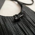 Close-up of fringe stitching and texture on Black tassel fringe hobo bag
