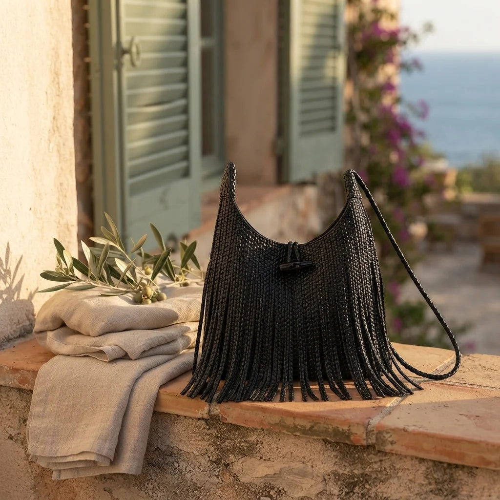 Black tassel fringe hobo bag styled in a warm Mediterranean setting
