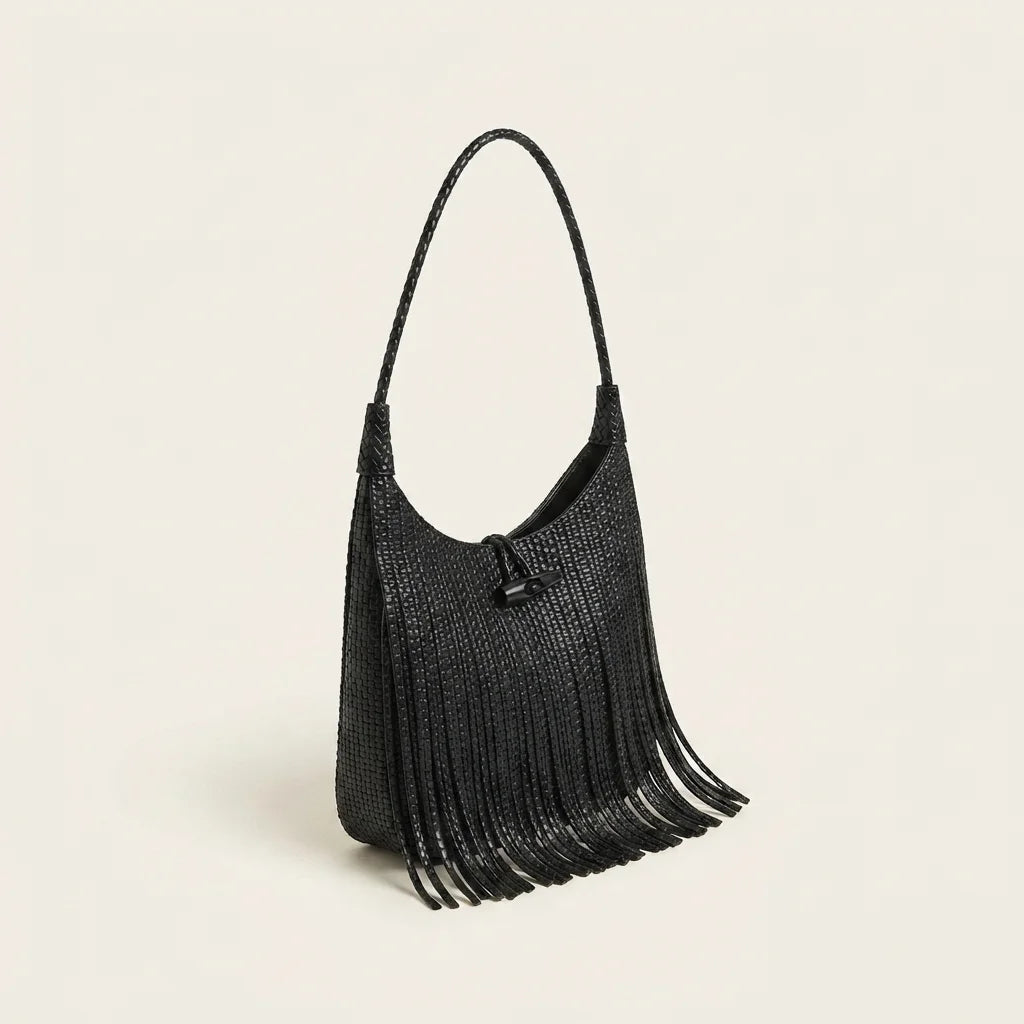 Black tassel fringe hobo bag, three-quarter angle showing side depth
