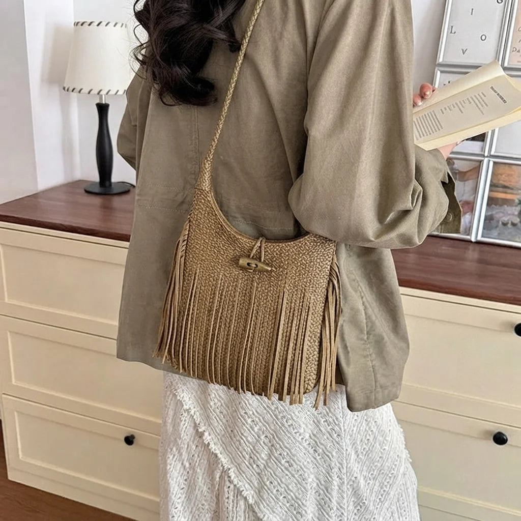 Khaki tassel fringe hobo bag, three-quarter angle showing side depth