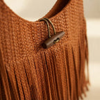Close-up of fringe stitching and texture on Orange tassel fringe hobo bag