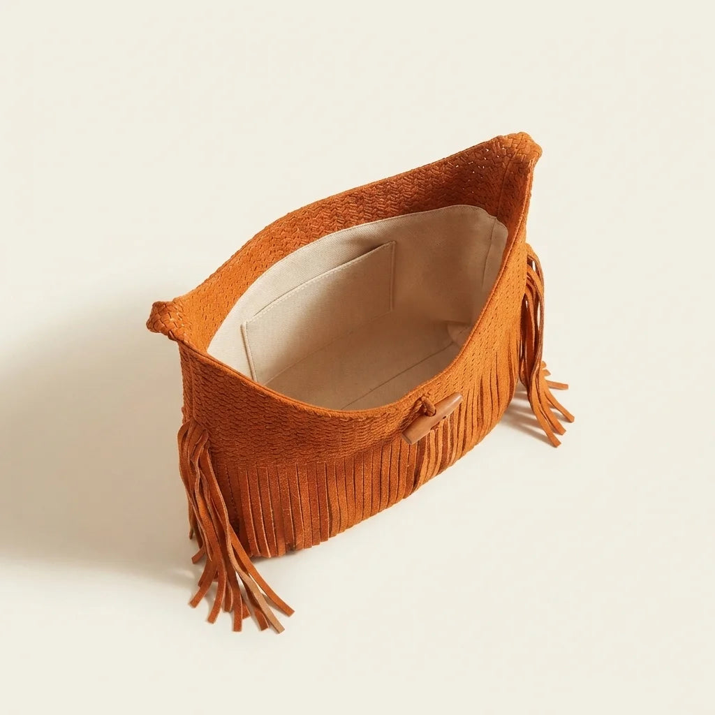 Interior lining and pockets of Orange tassel fringe hobo bag