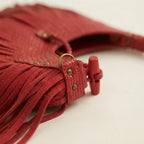 Close-up of fringe stitching and texture on Red tassel fringe hobo bag