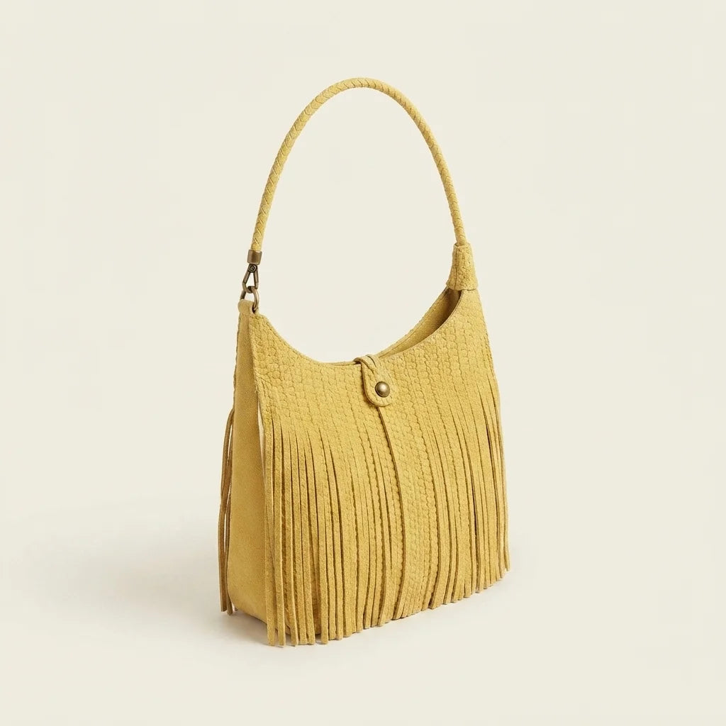 Yellow tassel fringe hobo bag, three-quarter angle showing side depth