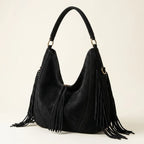 Black vegan fringe hobo bag, three-quarter angle showing side depth