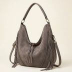 Grey vegan fringe hobo bag, three-quarter angle showing side depth