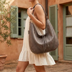 Woman wearing Grey vegan fringe hobo bag with swaying fringe