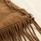 Close-up of fringe stitching and texture on Brown vintage boho fringe bag