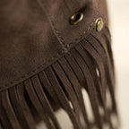 Close-up of fringe stitching and texture on Coffee vintage boho fringe bag