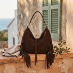 Coffee vintage boho fringe bag styled in a warm Mediterranean setting