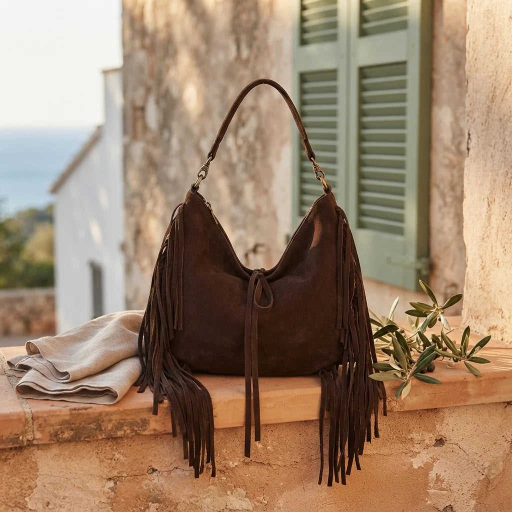 Coffee vintage boho fringe bag styled in a warm Mediterranean setting