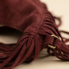 Close-up of fringe stitching and texture on Red vintage boho fringe bag