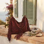 Red vintage boho fringe bag styled in a warm Mediterranean setting
