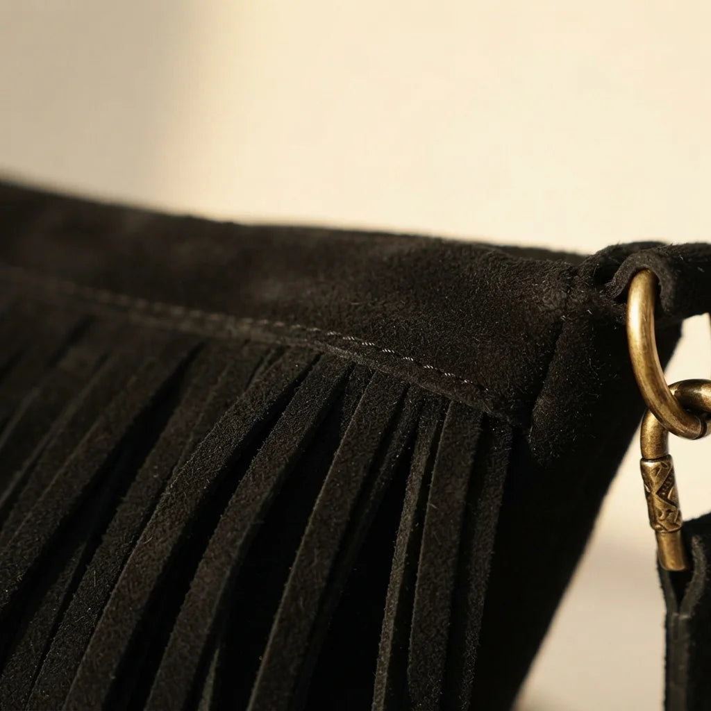 Close-up of fringe stitching and texture on Black vintage fringe hobo bag